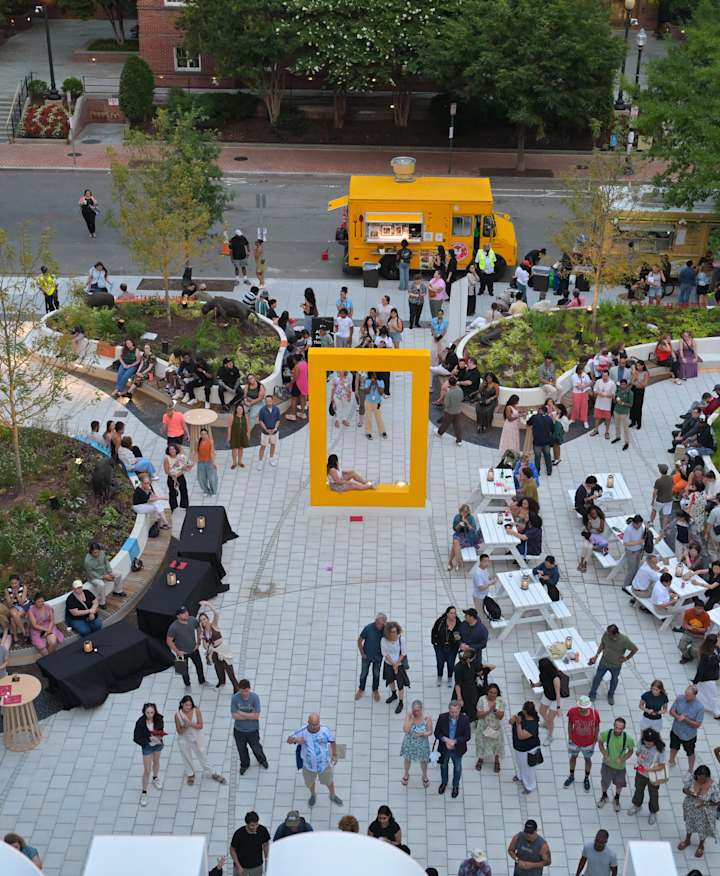 Overlooking the National Geographic Museum of Exploration courtyard filled with dozens of visitors.