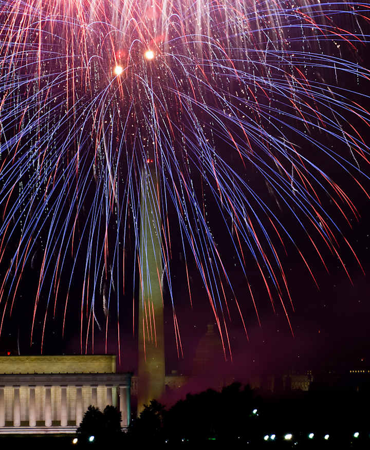 Fireworks reflecting over water.