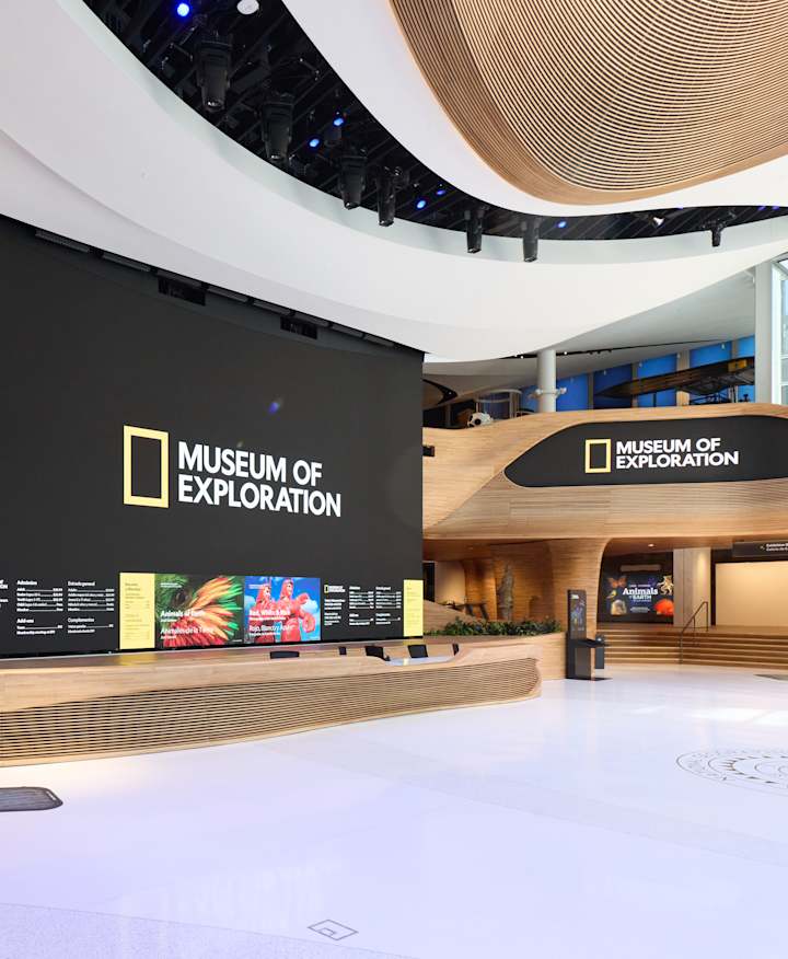 An empty pavilion with a large screen that has Museum of Exploration logo.