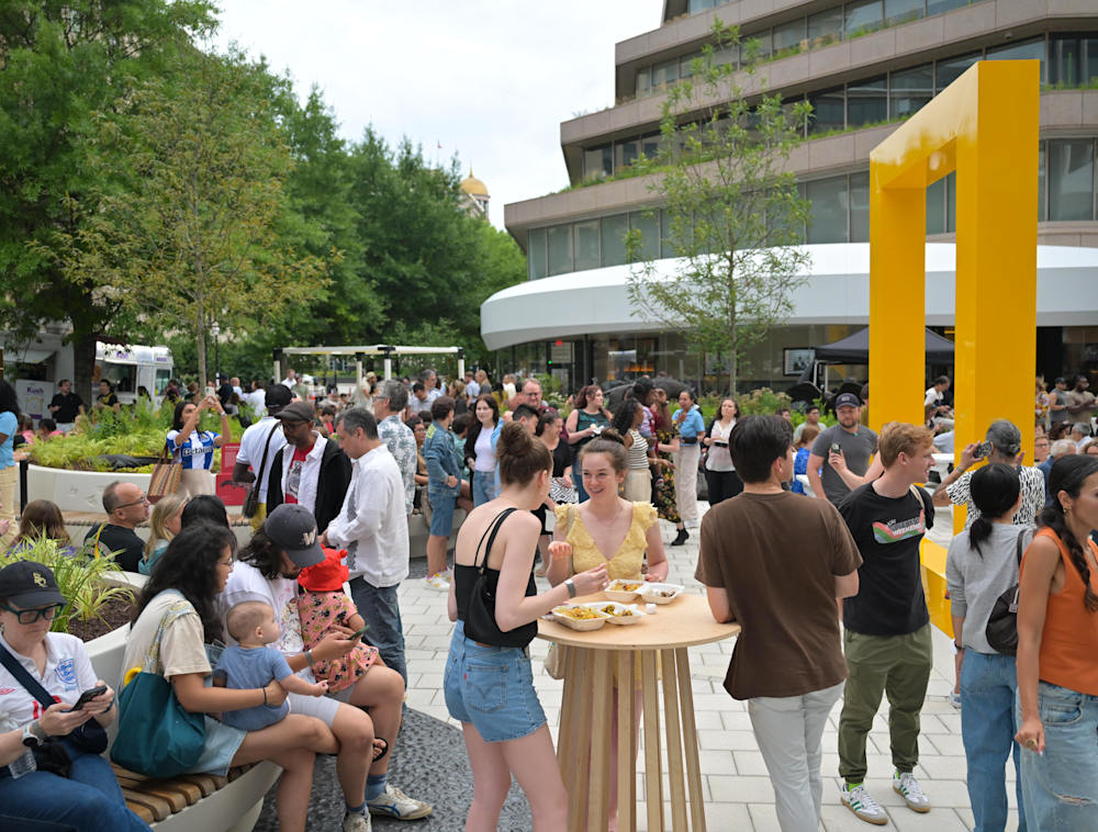Large group of people in the National Geographic Museum courtyard.