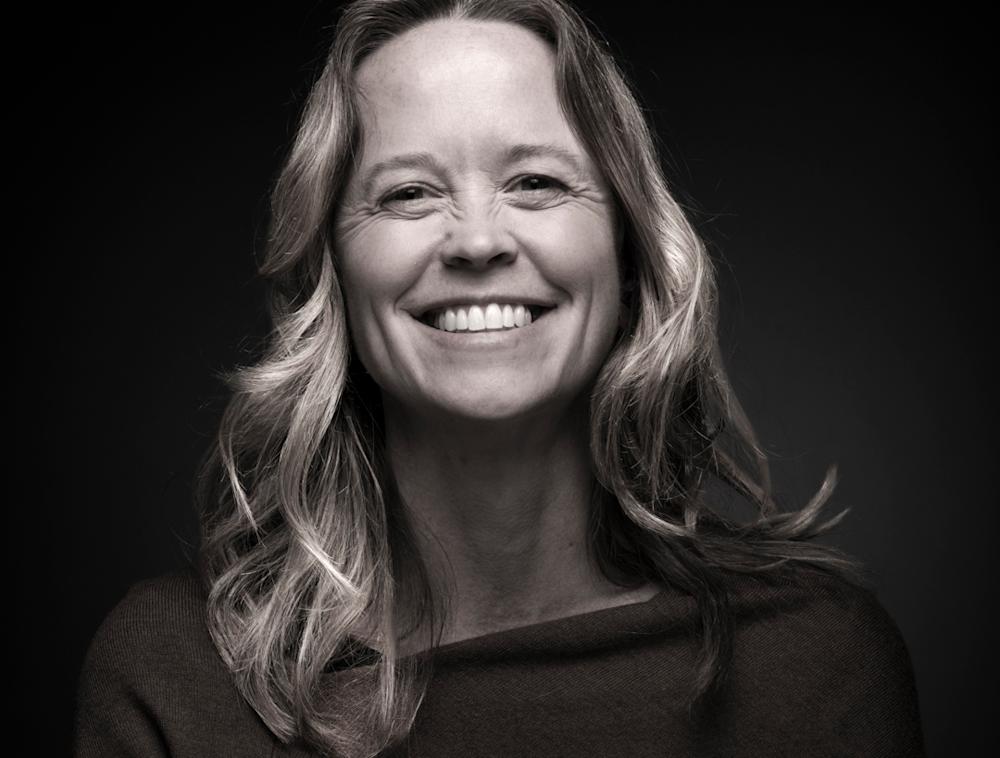 A black and white image of Amy Toensing smiling. 