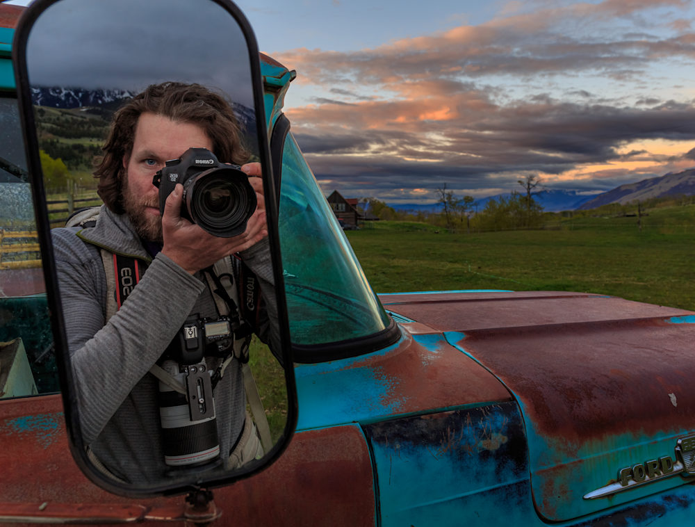 Ronan Donovan taking a picture of himself in a car mirror.