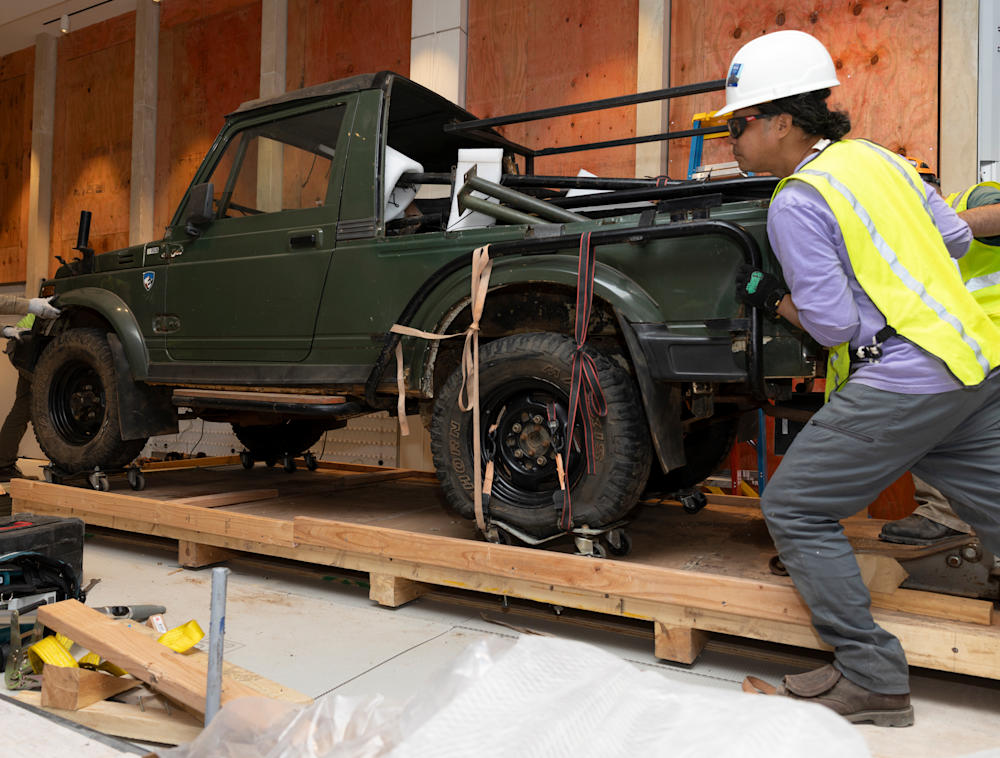 Behind the scenes photo of the Suzuki being placed in the Museum of Exploration.