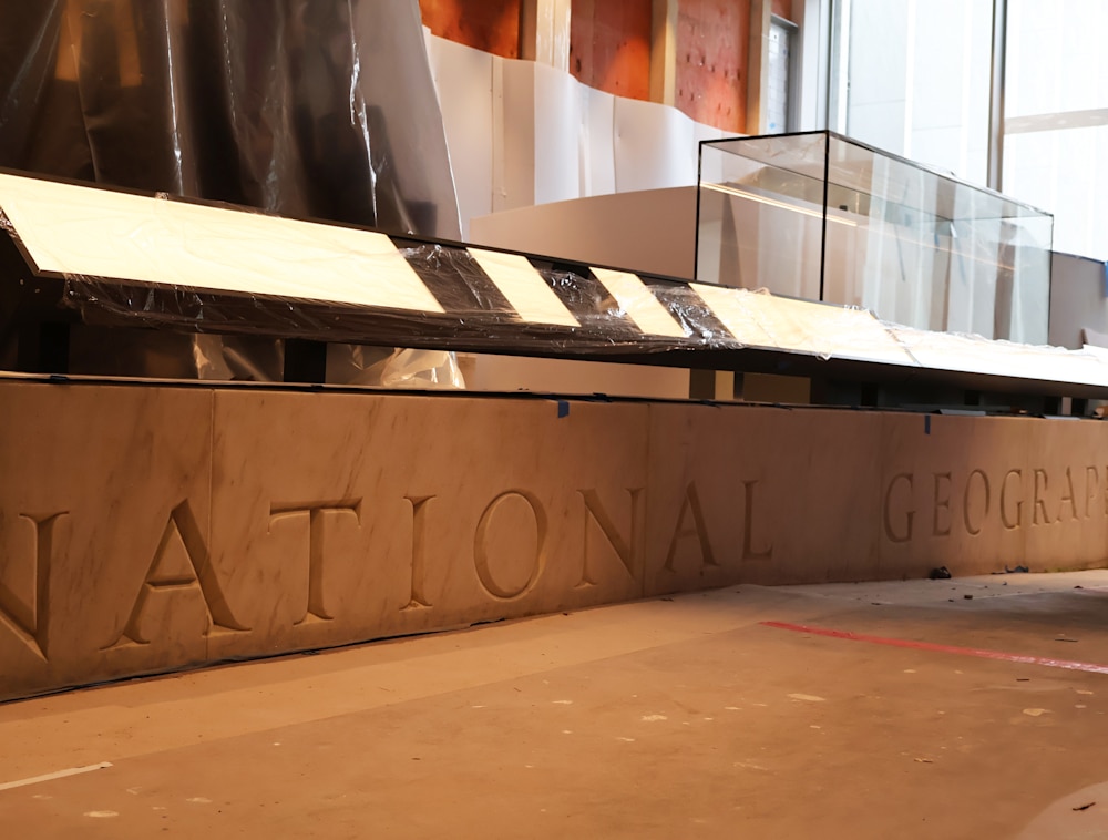 Repurposed Marble of the National Geographic name in the Pavilion of the Museum of Exploration.