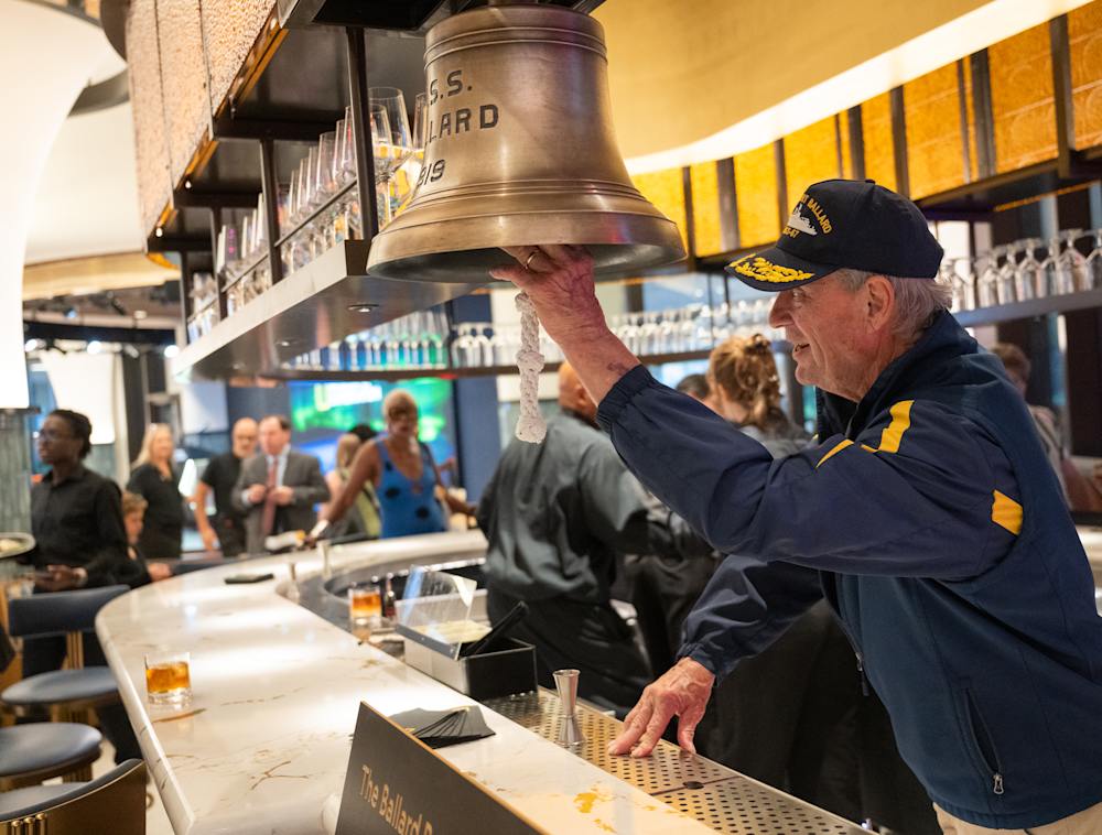 Bob Ballard ringing the bell at the Ballard Bar in the National Geographic Museum.