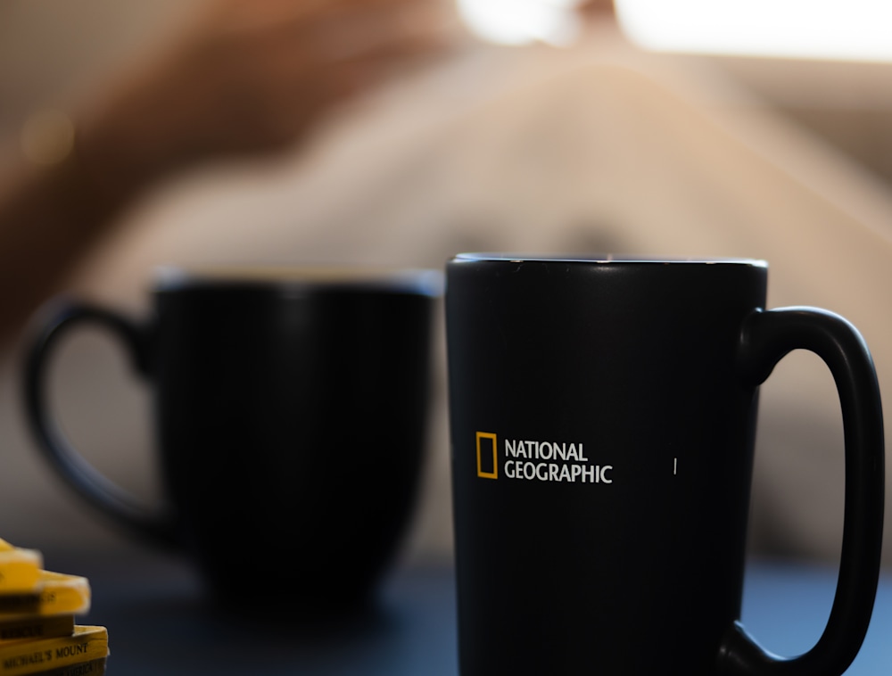 Two National Geographic coffee mugs next to each other.