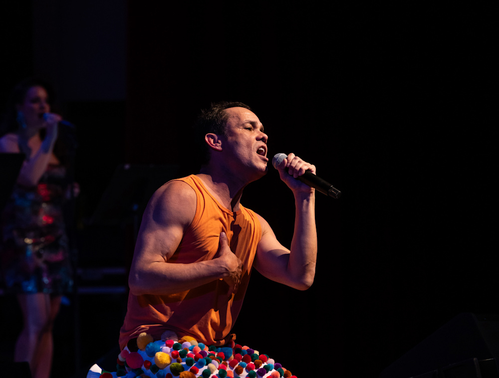 Migguel Anggelo singing on a stage.
