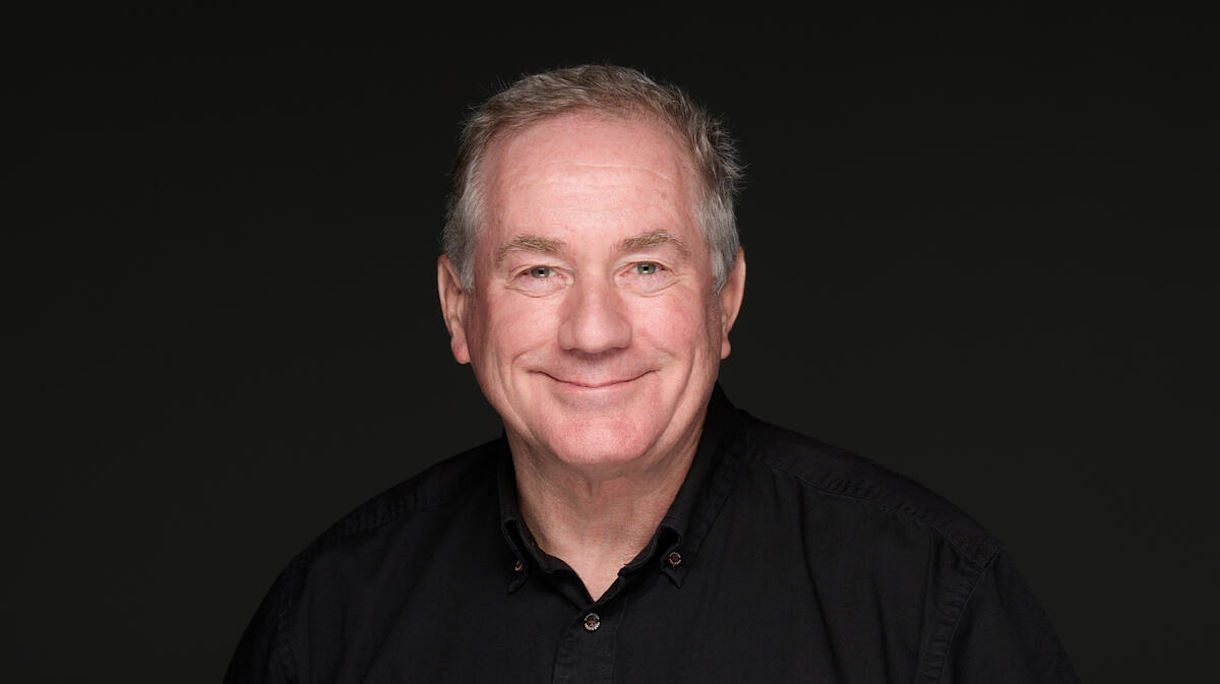 Headshot of Joel Sartore wearing a National Geographic Photo Ark shirt.