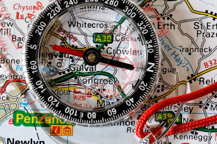 Photograph of a compass and map.