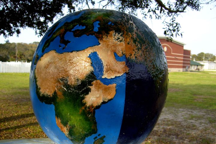 Photograph of a globe on a lawn.