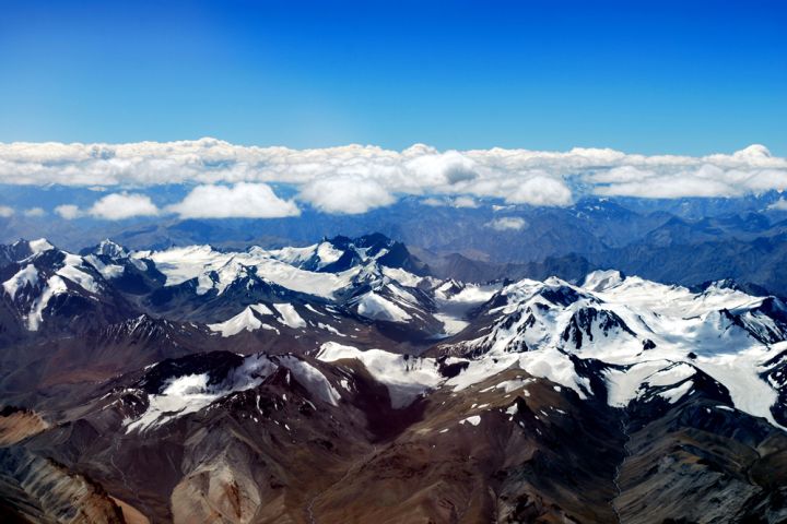 Photograph of snow covered mountain terrain.