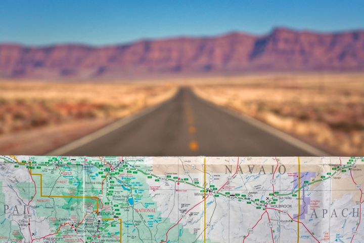 Photograph of a roadmap with the road and desert in the background.