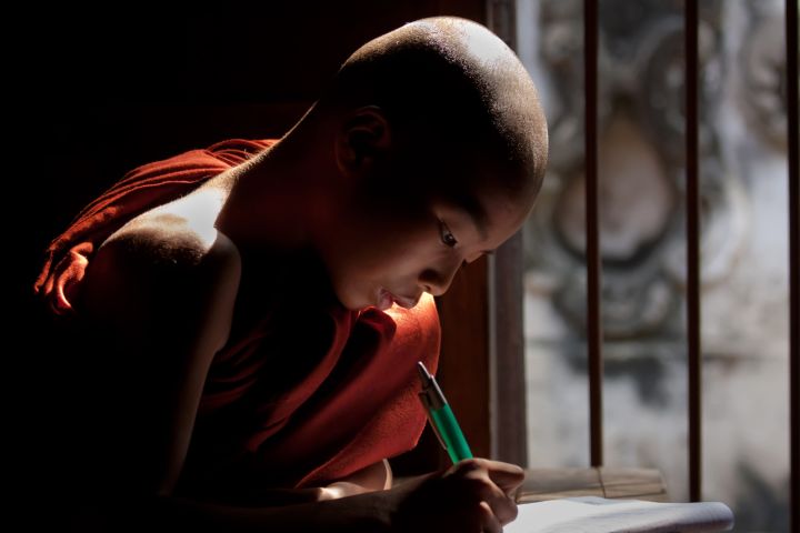 Picture of a monk writing.