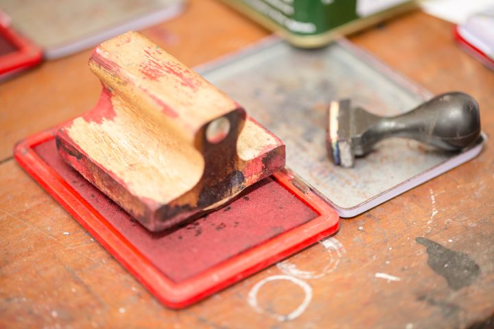 Red ink box and rubber stamp on wooden table