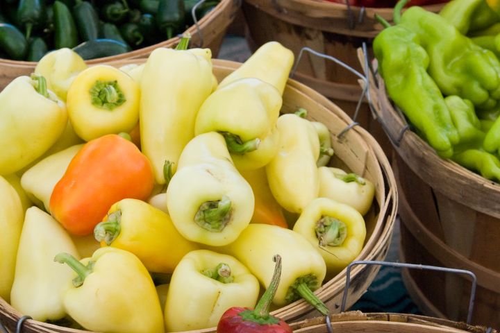 A photograph of peppers in baskets at a Farmers Market in Santa Fe, New Mexico.