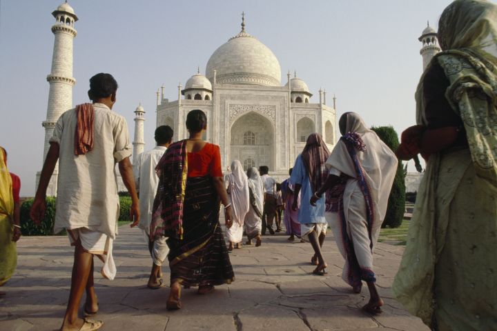 Pilgrims walk toward the Taj Mahal.