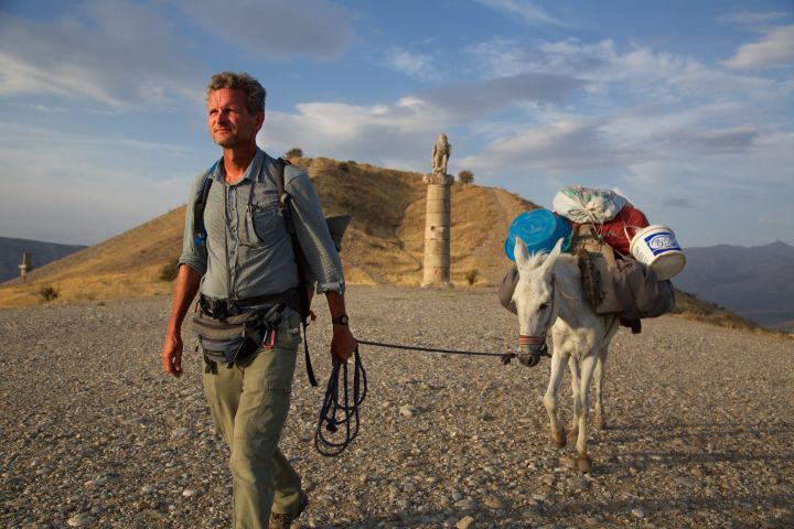 A journalist leads his mule past a royal tomb near Nemrut in eastern Turkey during his Out of Eden Walk, a seven-year global trek from Africa to Tierra del Fuego.