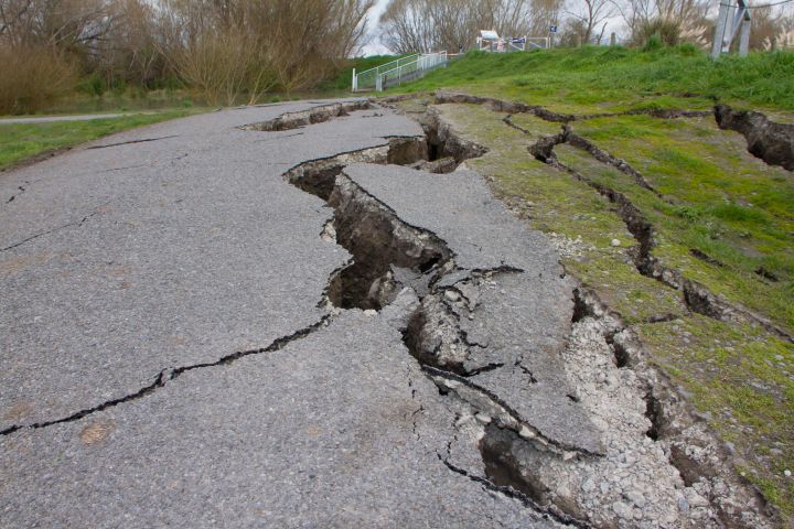 Photo of a road with cracks from a quake.