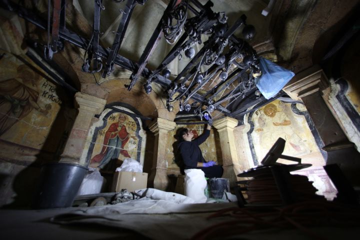 Members of the conservation team remove steel girders supporting the Edicule during restoration work, at the Church of the Holy Sepulchre in Jerusalem's Old City