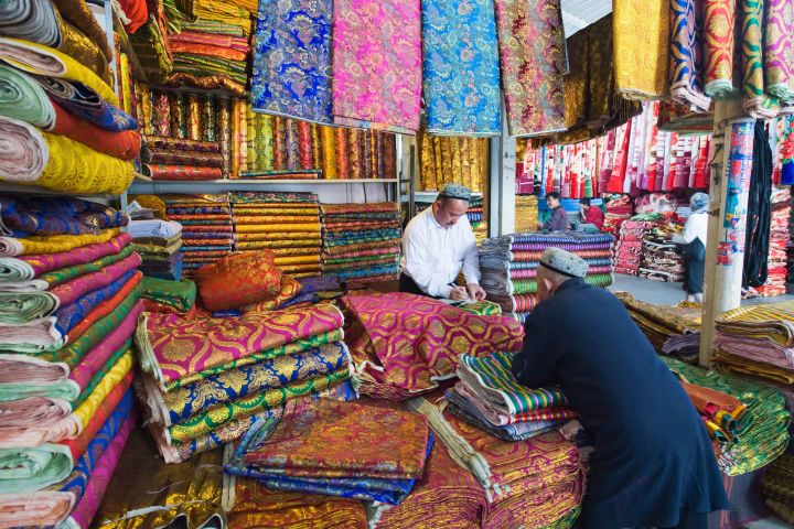 The Silk Road gets its name from the selling of silk fabrics, shown here being sold in a market in Xinjiang Provice, China.