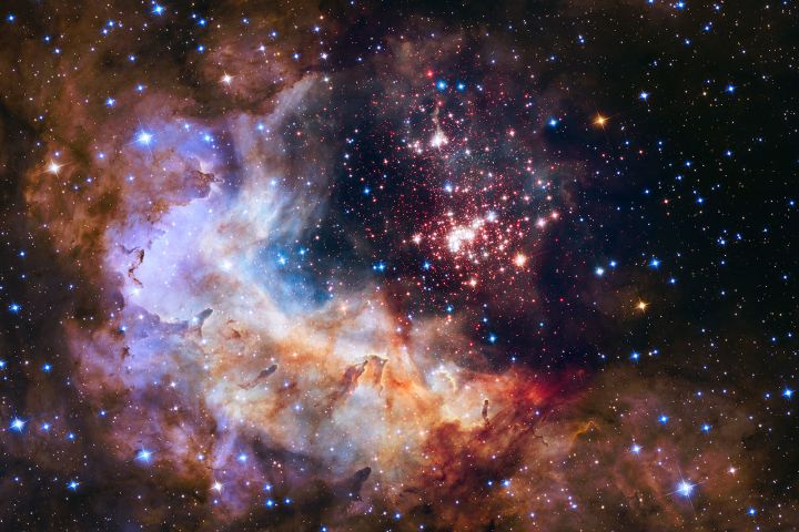 A look at a giant star cluster and a nebula, an interstellar nursery for new stars, visualized by NASA's Hubble Space Telescope’s near-infrared Wide Field Camera 3.