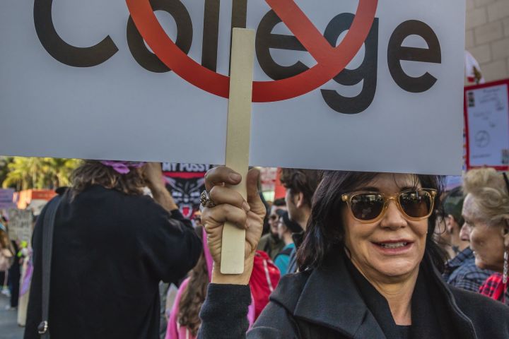 A woman holds a sign protesting the electoral college system the day after the inauguration of Donald J. Trump as president of the United States on January 21, 2017, in Los Angeles, California.