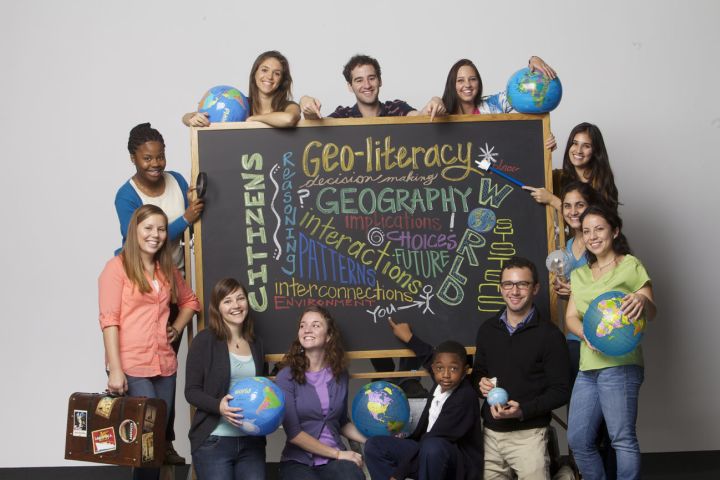 Picture of students around a chalkboard.