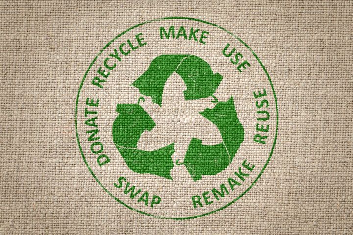 Green recycling logo on a burlap sack