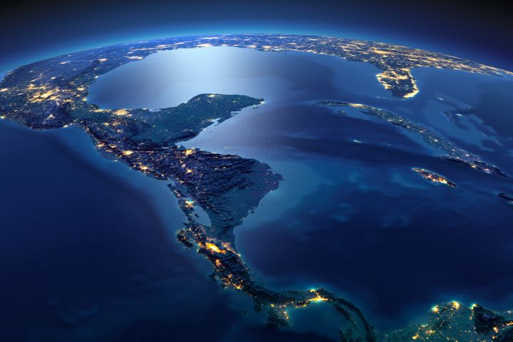 A view of Earth at night focused on the Atlantic and Pacific Oceans at the nexus of the Americas.