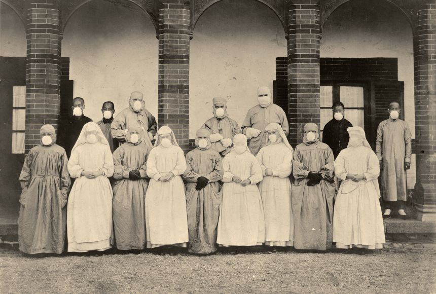 In order to combat plagues while avoiding infection, hospital staff like this missionary team in Asia in the 1910s wore protective clothing, including gloves, face masks, and often headgear.