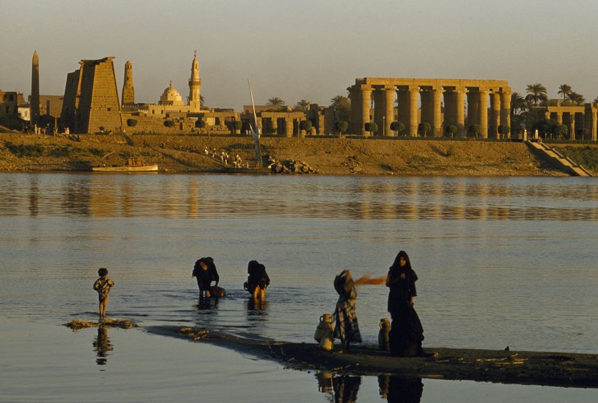 Even today, families come to the banks of the Nile River to gather water for their day, against the backdrop of ancient Egyptian ruins.
