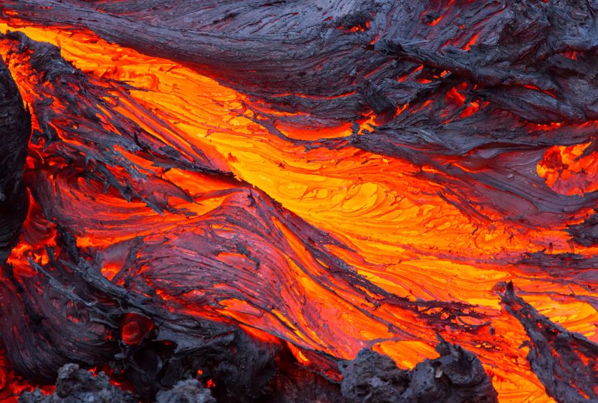 Lava (magma that has erupted onto Earth's surface) is visually mesmerizing – as the molten rock flows downhill, lava exposed to the air cools to a deep black color, while the molten rock beneath glows bright orange.