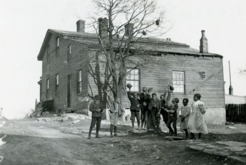 Historic image of the home of American Quaker and abolitionist Levi Coffin located in Cincinnati, Ohio, with a group of African Americans out front.