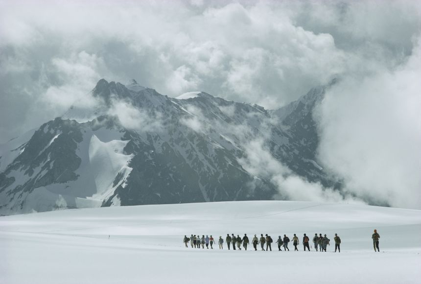 Hikers traversing the plains below Russia's Mount El'brus. Part of the Caucasus Mountains, it is the highest above-ground peak in Europe.