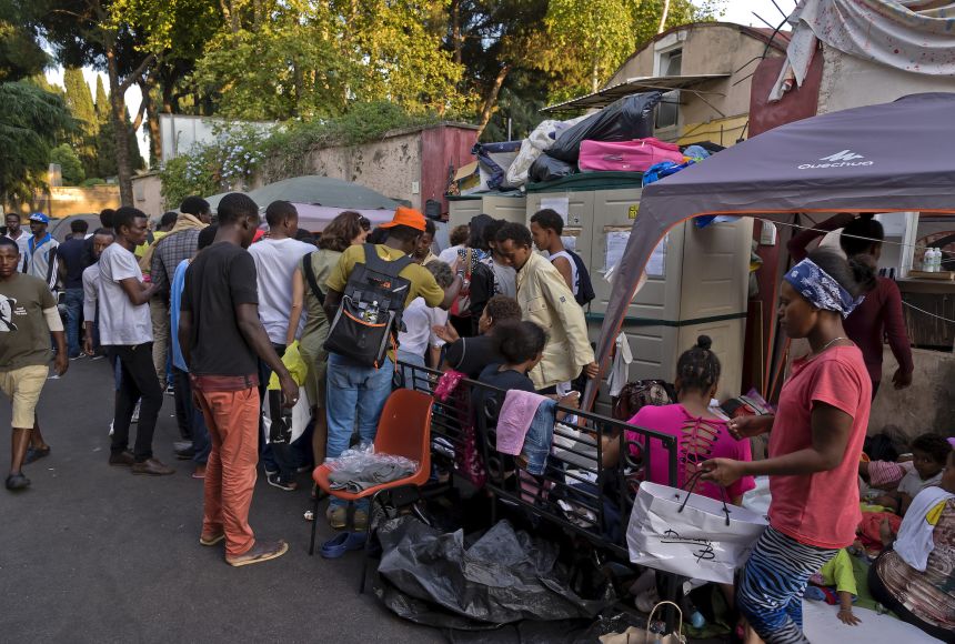 People displaced from their homes because of war and conflict—as some of the migrants shown here in Rome, Italy, likely are—often are vulnerable to hunger.