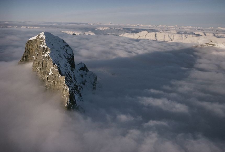 The summit of Mount Alberta in Jasper National Park in Alberta, Canada, peaks up through a thick layer of cloud cover.