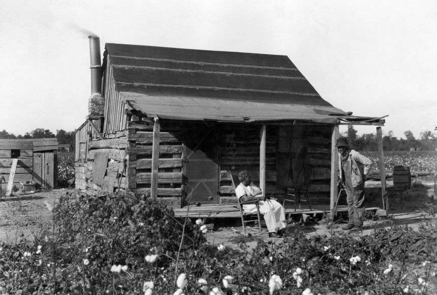 The 13th Amendment ended enslavement in the United States. Here, a formerly enslaved African-American couple is shown at their cabin in the 1890s.
