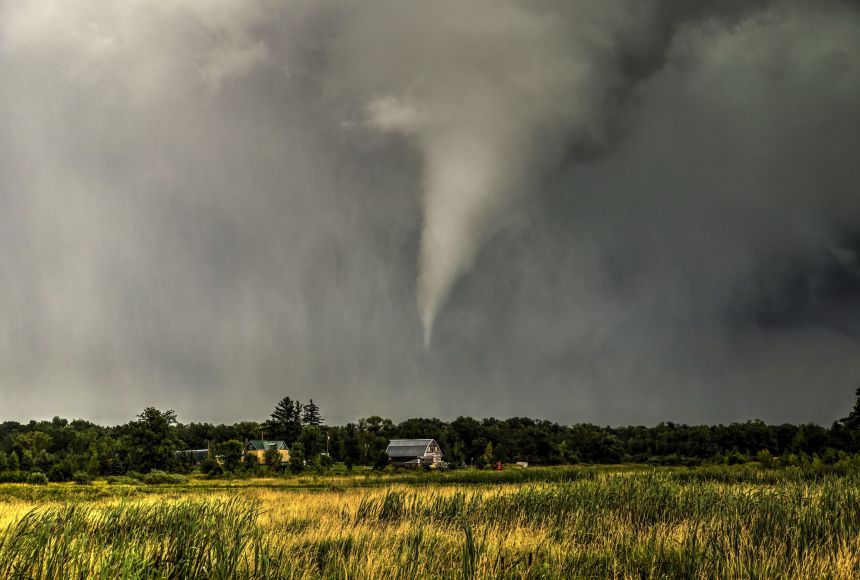 While the number of tornadoes in the states that make up Tornado Alley are falling, they are becoming more prevalent in some other places. Here, a tornado drops onto the central Minnesota plains, narrowly missing a farm house.