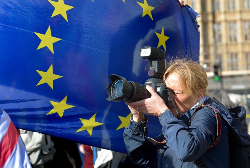 Photographs have become the medium of choice for documenting events around the world. Here, a photographer shooting a Brexit protest in front of an European Union flag in London, England, in March 2019.