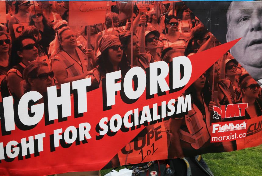 The economic philosophies of socialism and capitalism are opposed. Protesters demonstrate against a plan to sell off public healthcare (a socialist stance) to private corporations (a capitalist stance) on April 30, 2019 at Queen's Park in Toronto, Ontario