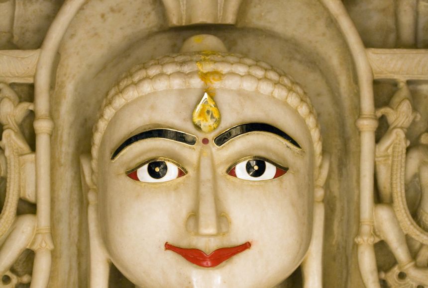 A hand carved statue of Mahavira made from marble, inside a Jain temple in Jaisalmer Fort, Rajasthan, India. Also known as Vardhamana, Mahavira was a tirthankara or a teacher of the dharma.