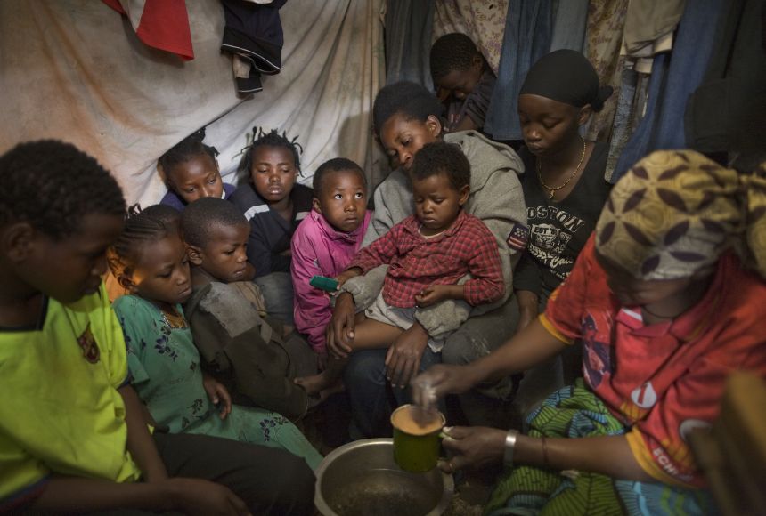 a mother feeding her 10 children in Kenya