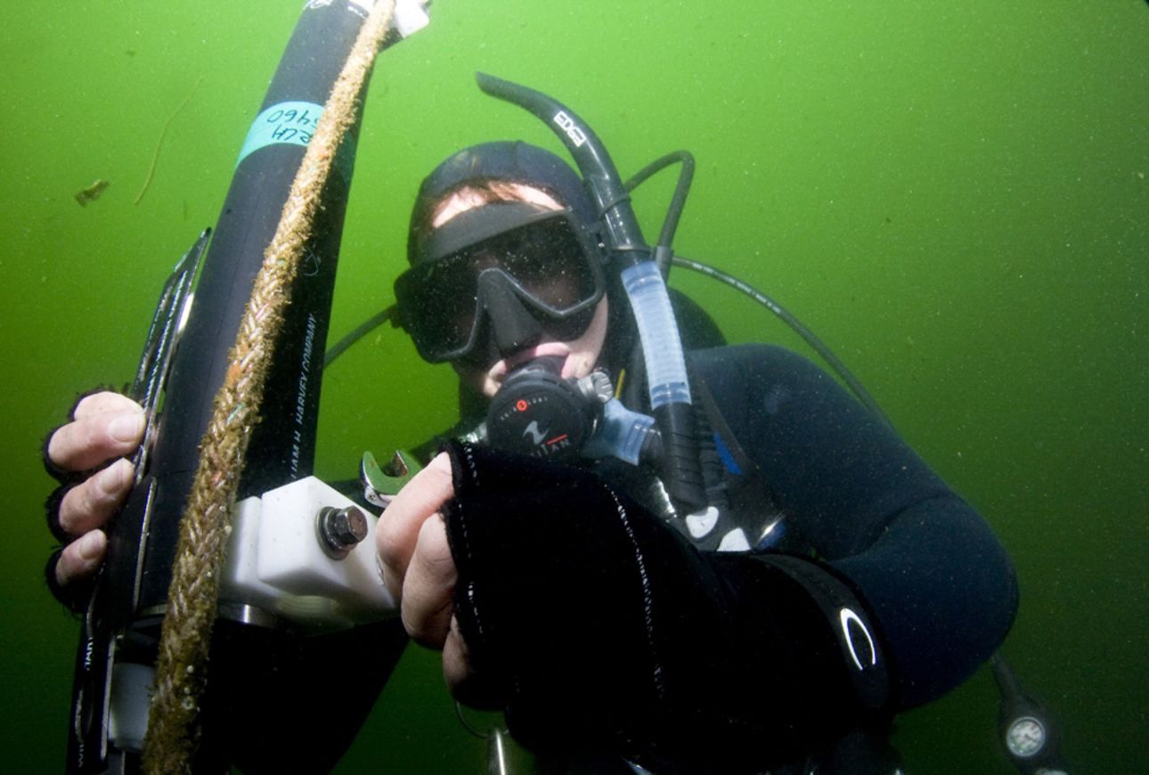 Photo: Scuba diver holds a tool.