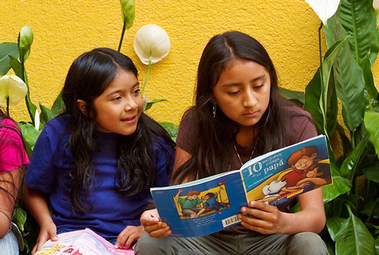 Photo of two girls reading.