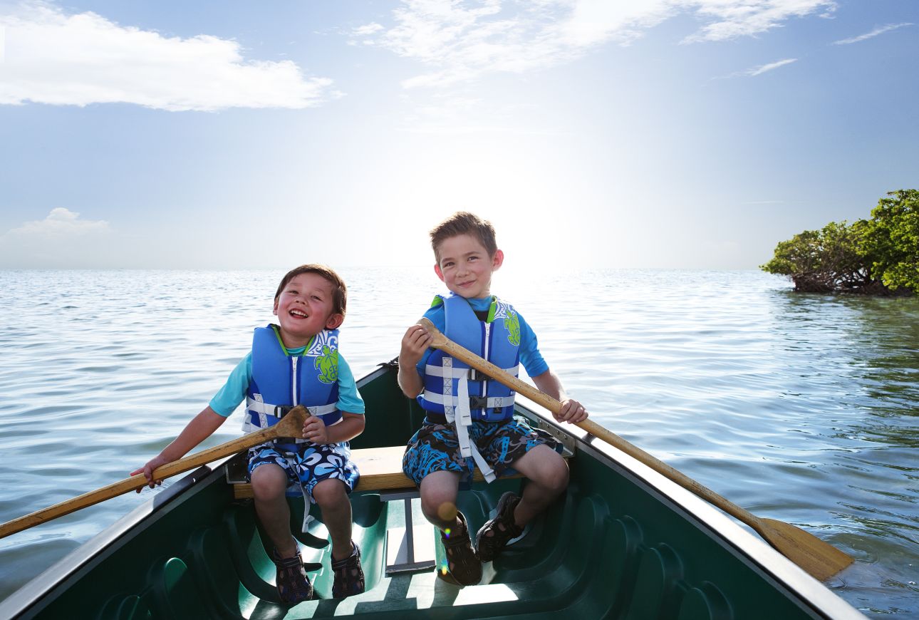 Brothers paddling a canoe