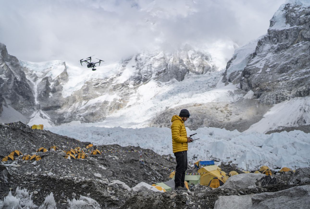 Researcher flying a drone to create a map of mount Everest.