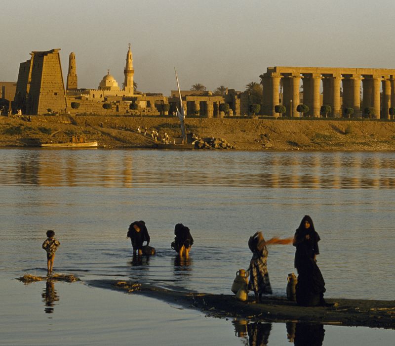 women and children on the banks of the nile