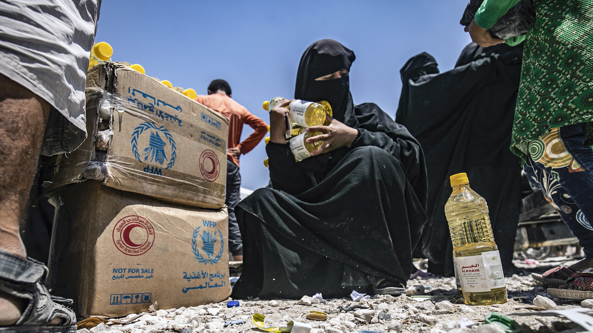 https://images.nationalgeographic.org/image/upload/v1638892251/EducationHub/photos/syrian-woman-gets-food-aid.jpg